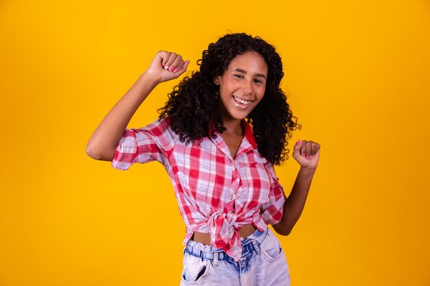 Woman dressed in June party outfit dancing