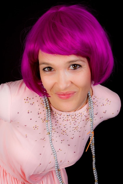 Woman dressed in shiny outfit and purple wig