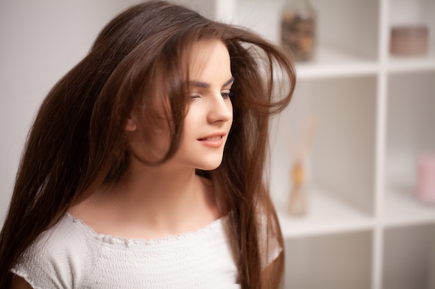 Photo woman dries her hair dryer at home