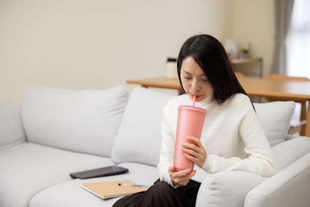 Woman drink a bottle of water at home