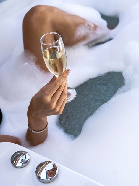 A woman drinking champagne in the jacuzzi