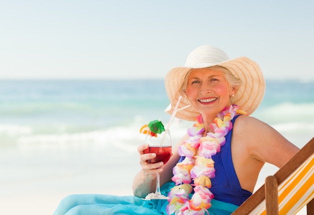 Woman drinking a cocktail in her deck chair