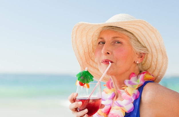 Woman drinking a cocktail in her deck chair