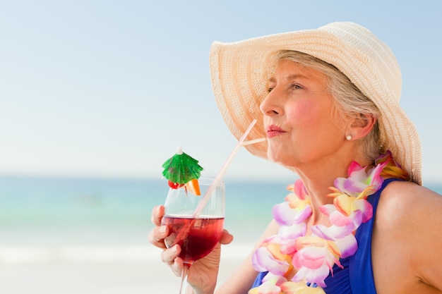 Woman drinking a cocktail in her deck chair