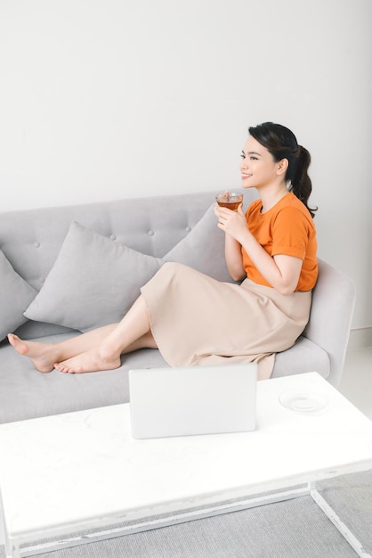 Woman drinking coffee on sofa