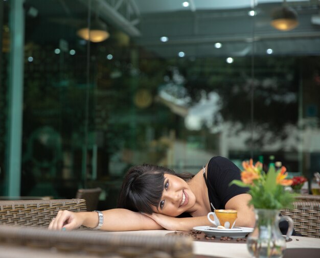 Woman drinking coffee table. 