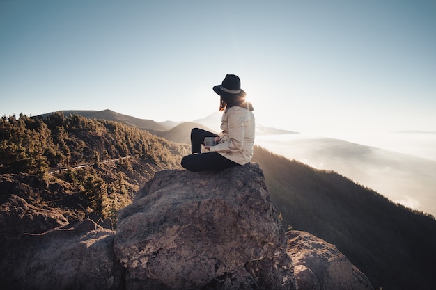 woman drinking coffee while watching nature