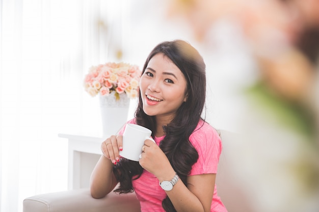 Woman drinking a cup of tea or coffee