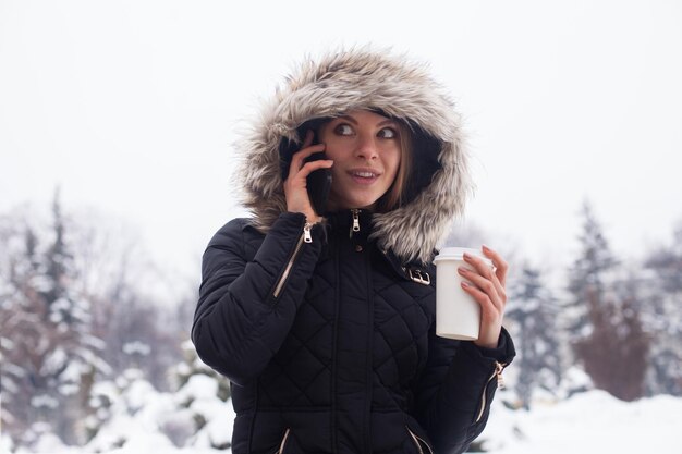 Woman drinking her hot beverage from cup. Winter season.