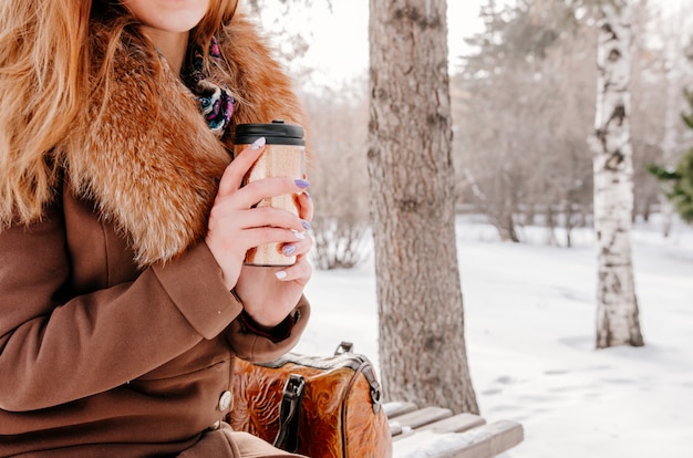 Photo woman drinking hot tea from thermo cup