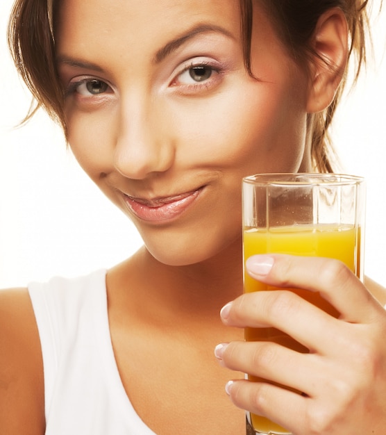 Woman drinking orange juice close up