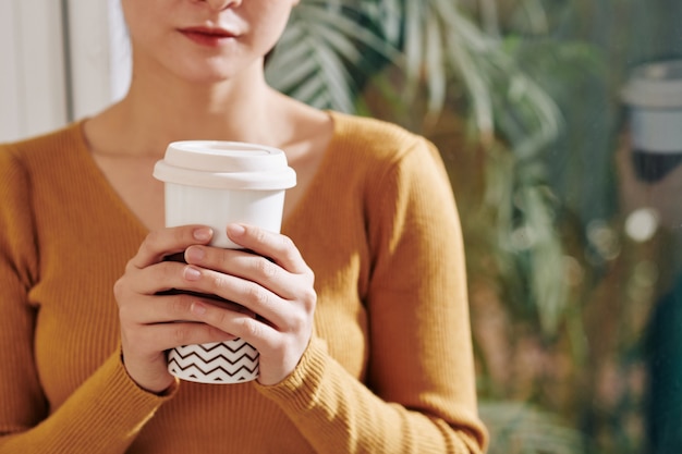 Woman drinking take out coffee