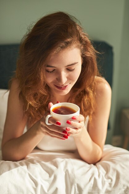 Woman drinking tea in morning