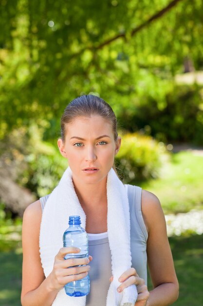 Woman drinking water after the gym