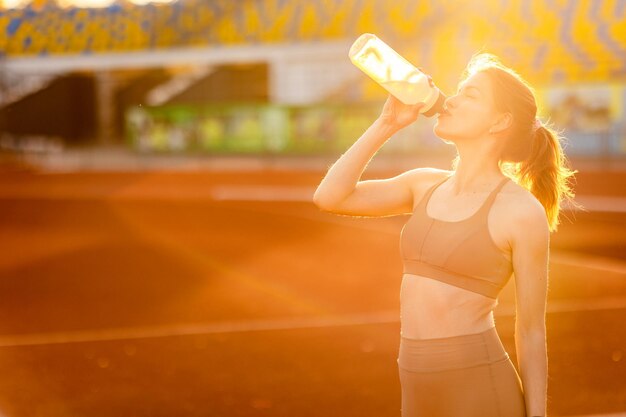 A woman drinking water from a bottle