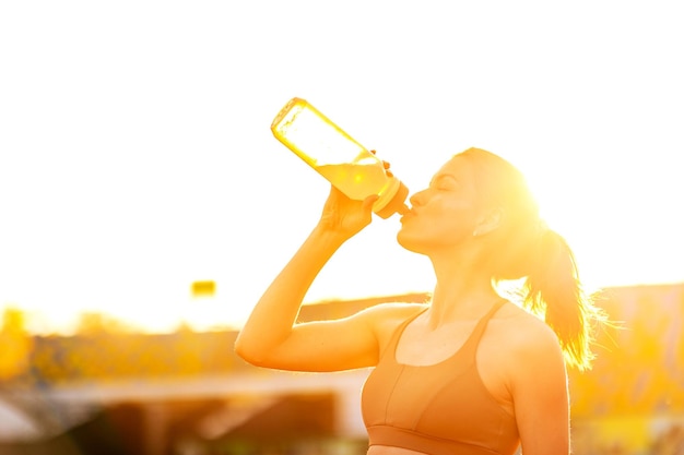 A woman drinking water from a bottle