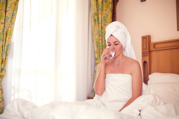 Woman drinks fresh water in the morning. People, healthcare, lifestyle concept