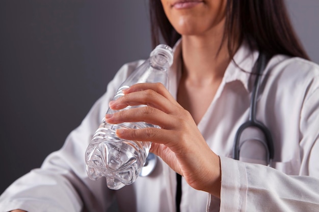 woman drinks water from a plastic bottle