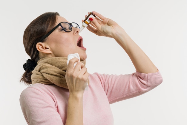 Woman drips drops for nose