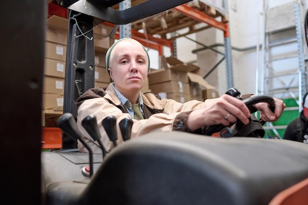 Woman driving a forklift in a warehouse