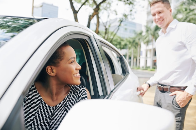 Woman driving man in a car