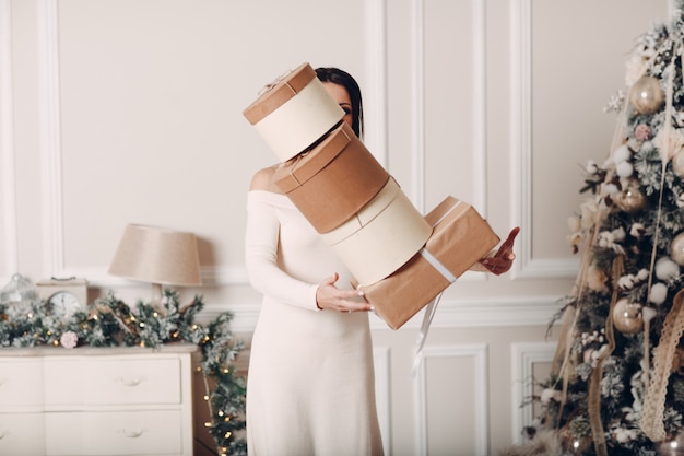 The woman drops the boxes with gifts