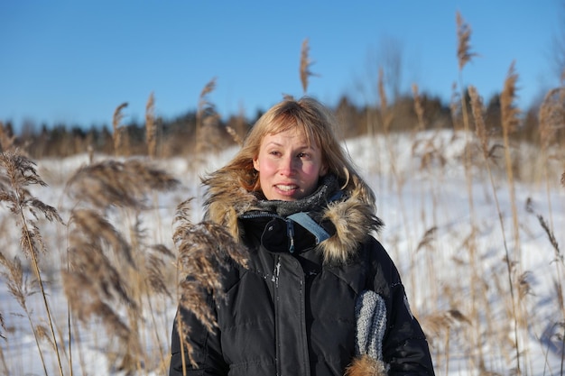 Woman in dry grass in winter