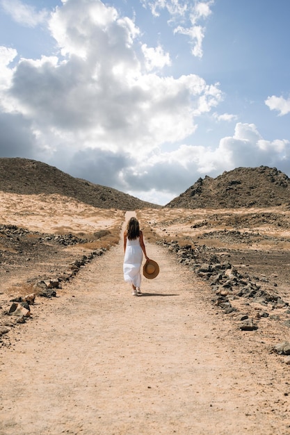 Woman on dry road in mountains