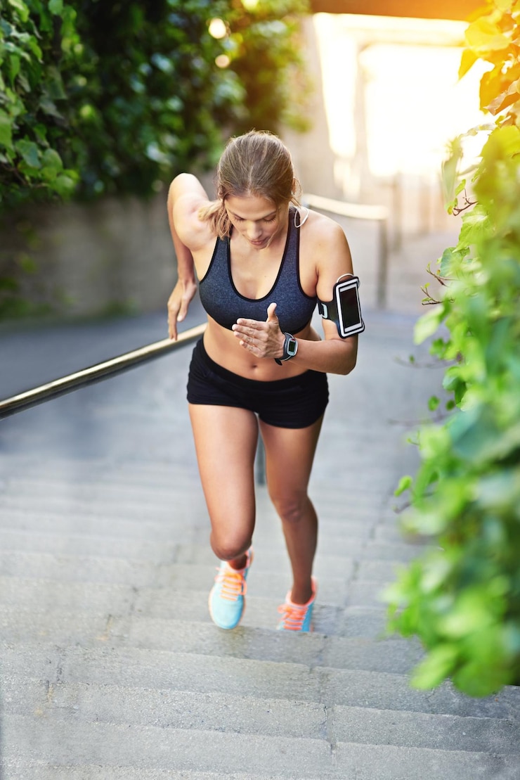Photo woman earphones and stairs and run for workout endurance and outside for cardio health fitness sports or steps with cellphone for training with audio or music athlete person or streaming podcast