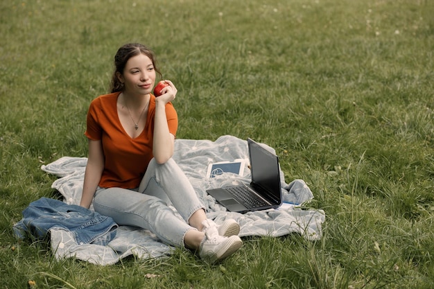 Woman eat apple in park