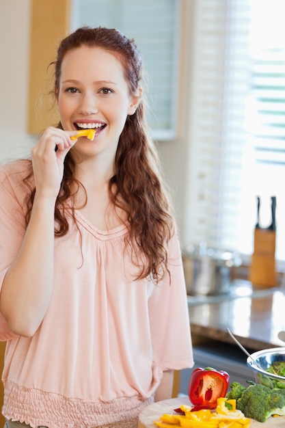 Woman eating bell pepper