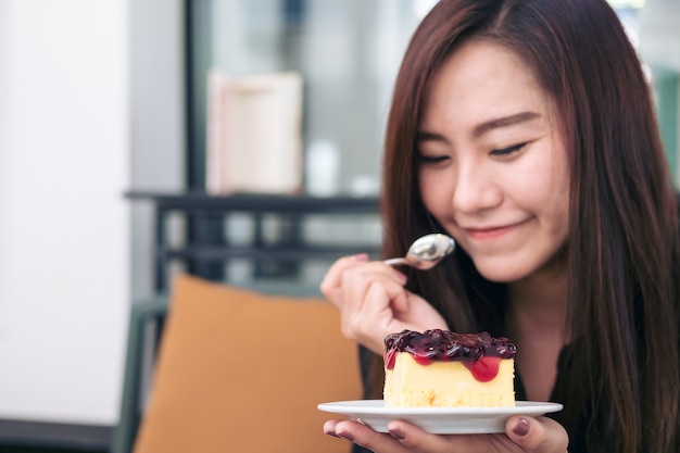 woman eating blueberry cheese cake