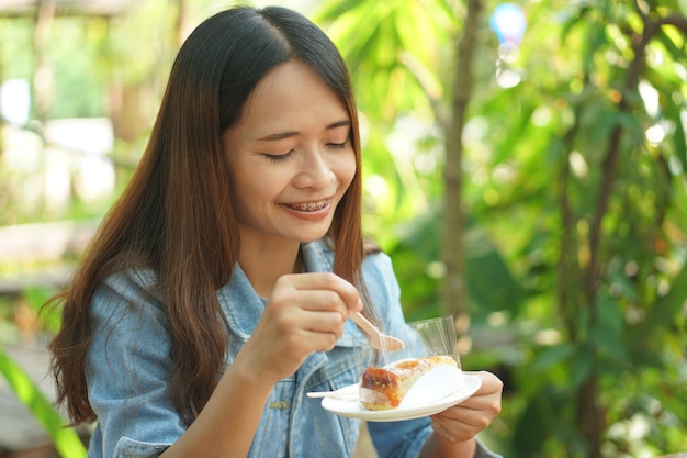 Woman eating cake in coffee cafe