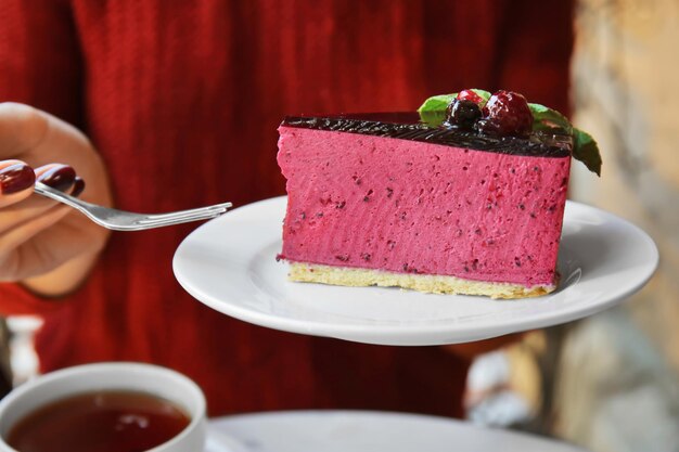 カフェでおいしいケーキを食べる女性