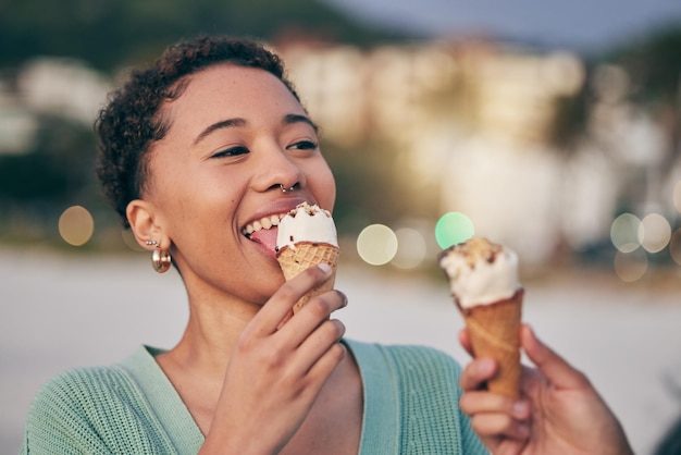 Photo woman eating ice cream and beach with smile thinking and memory for sweets treat and cone on summer vacation african girl gelato and happy for dessert food or candy by ocean for holiday outdoor