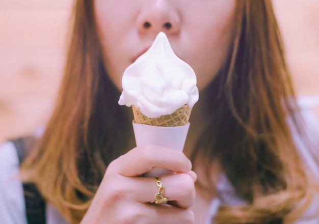 Foto donna che mangia il gelato su un cono.