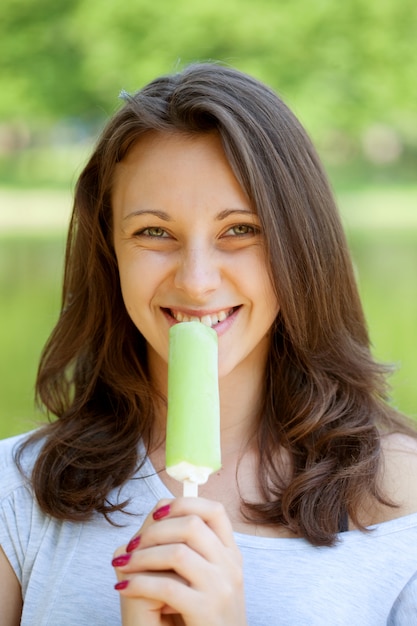 Woman eating ice-cream sunny day outdoors 