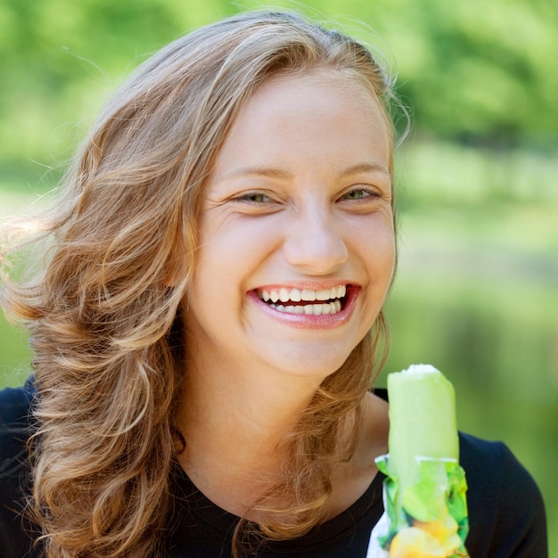 Woman eating icecream sunny day outdoors