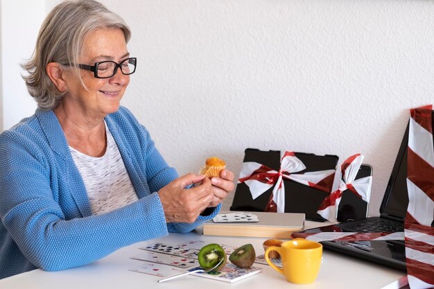 Woman eating muffin at home