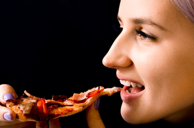 Woman eating pizza