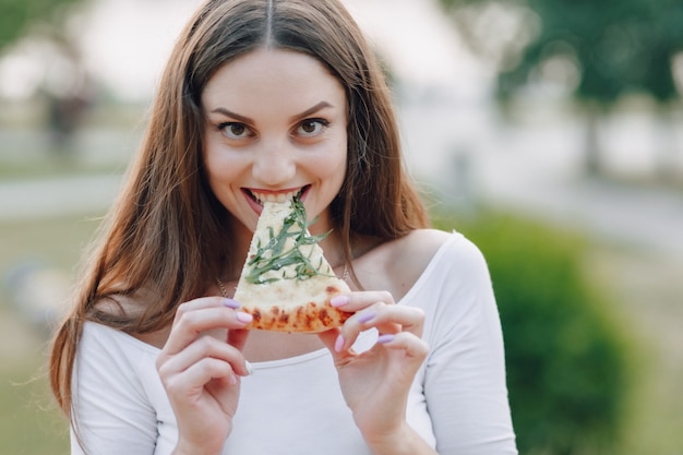 Woman eating pizza