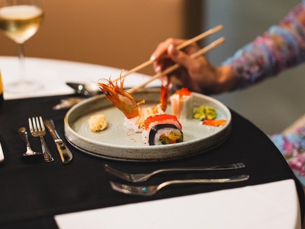 A woman eating sushi for dinner