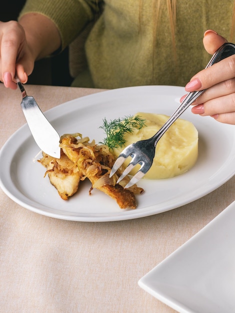 woman eats her lunch in restaurant fish and chips