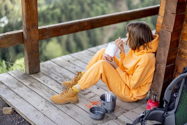 Woman eats while traveling in the mountains