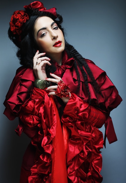 Woman in elegance red costume with red hat.