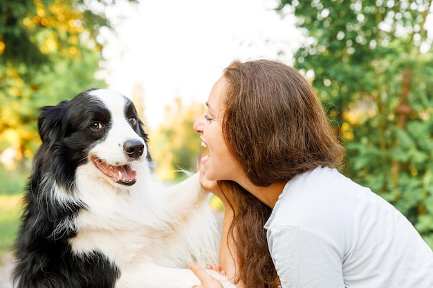 Photo woman embracing dog snout at park