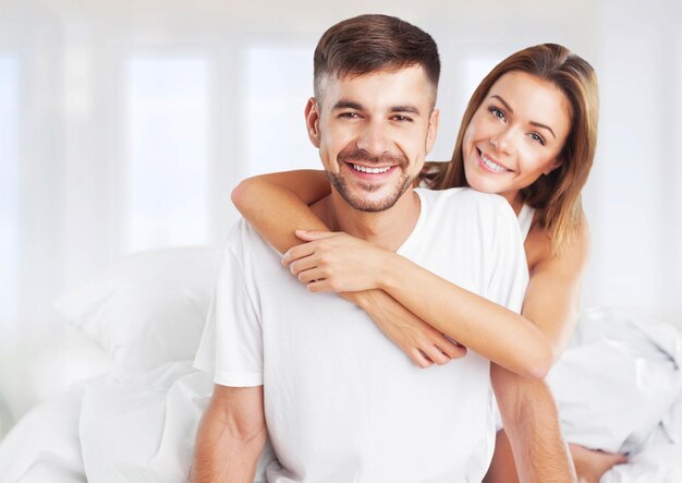 woman embracing her partner in bed