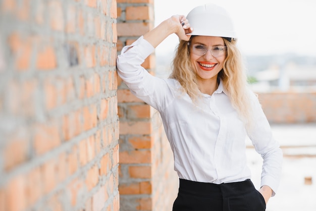 Woman Engineer look at Building Glass.