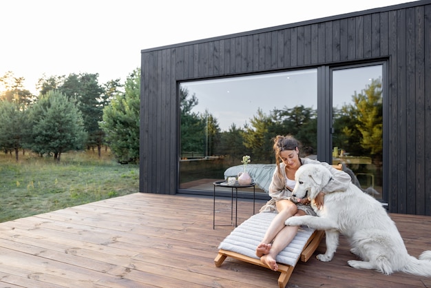 Woman enjoy nature at country house with pet