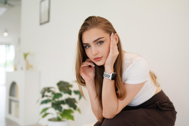 Woman enjoy posing in minimal white place. Minimal white place and background and beautiful blonde Caucasian lady in minimal cafe's interior.